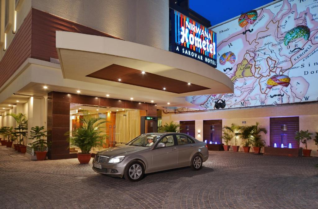 a small car parked in front of a building at Nirwana Hometel Jaipur- A Sarovar Hotel in Jaipur