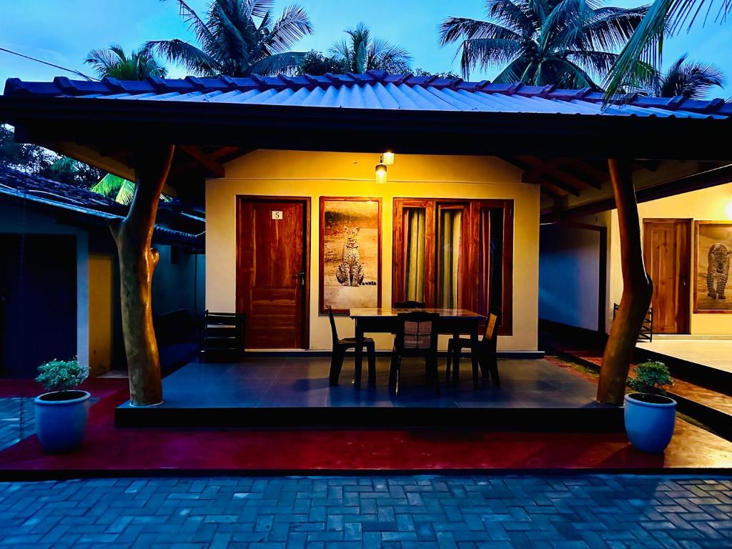 a house with a table in front of it at Wilpattu Blue Sapphire lite - B&B in Wilpattu