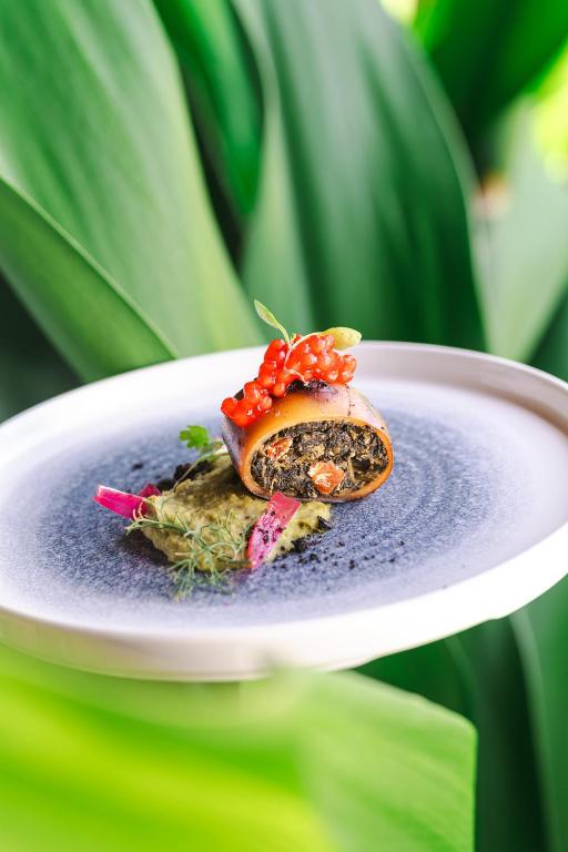 a plate with a piece of food on it at Zanzibar Queen Hotel in Matemwe