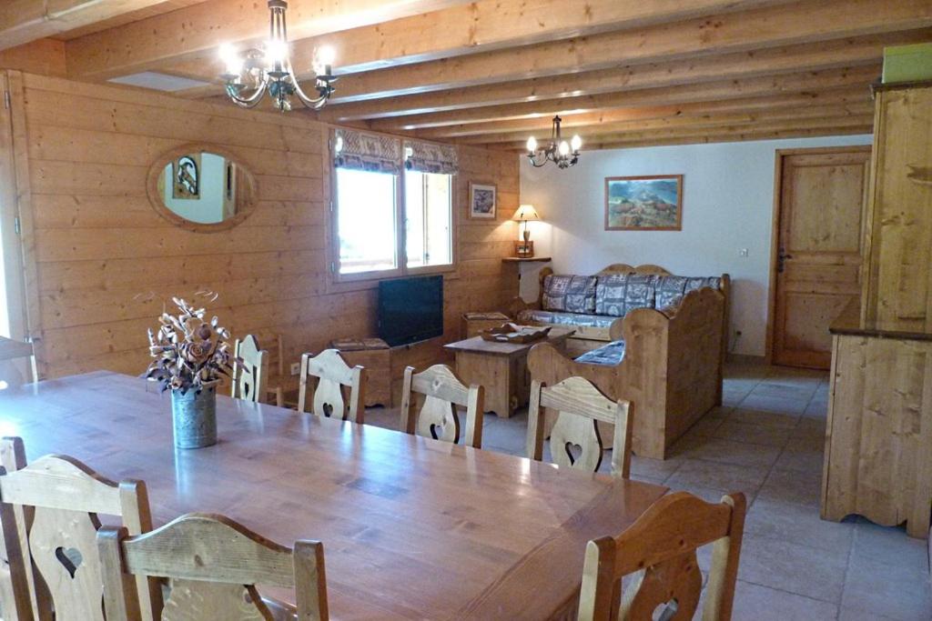 a dining room and living room with a table and chairs at Chalet ambiance montagne, 10 personnes, 4 chambres - CH15 in Beaufort
