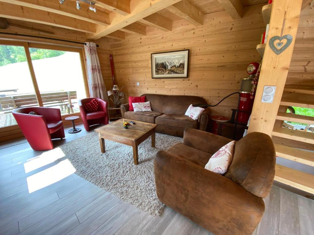 a living room with a couch and a table at Chalet neuf, 8 personnes, 3 chambres - CH32 in Beaufort