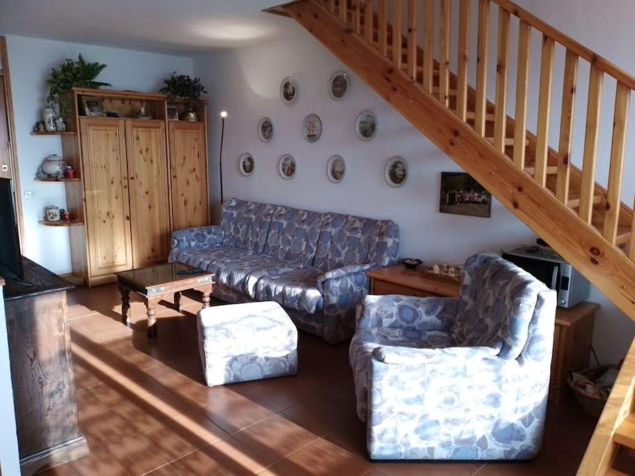 a living room with a couch and a staircase at Appartamento - Pila Ciel Bleu - Il balcone sulle Alpi in Pila