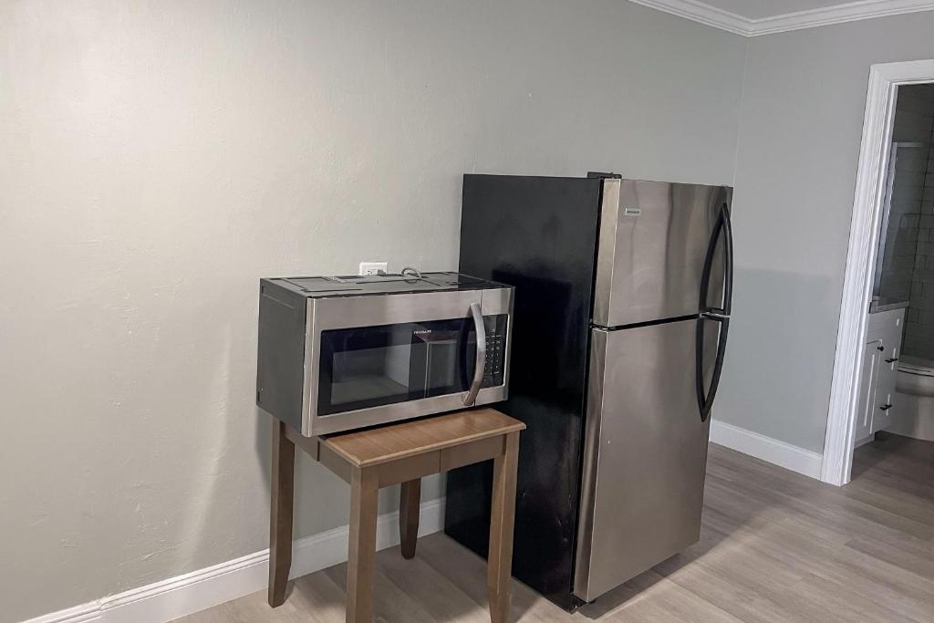 a microwave on a table next to a refrigerator at Marco Island Lakeside Inn in Marco Island