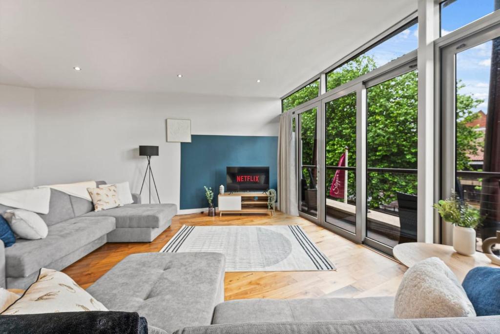 a living room with couches and a large window at Modern Luxe Living in Lincoln - Flat 3 in Lincolnshire