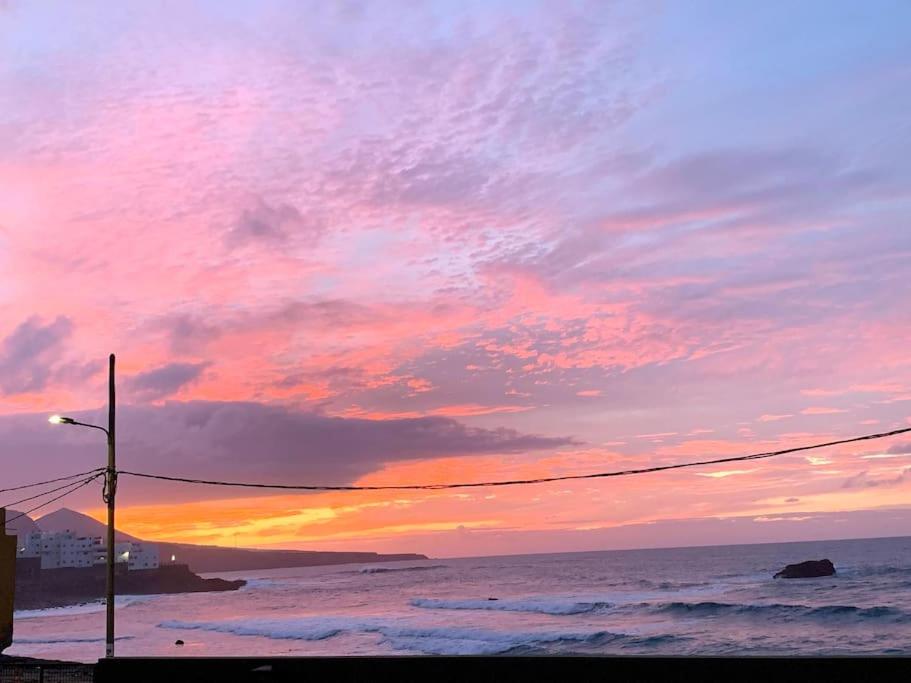 a sunset at the beach with a street light at Blue Sea in Moya