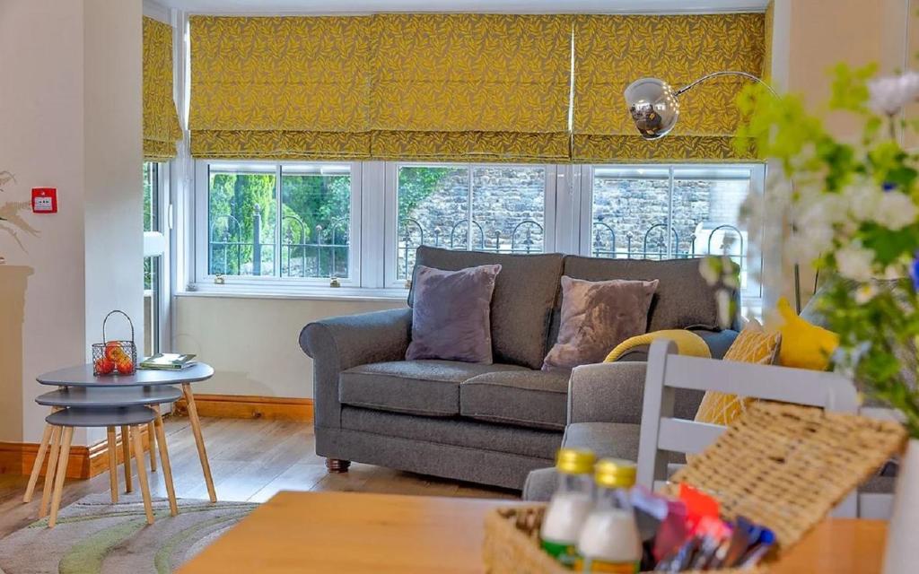 a living room with a couch and a table at Howgills Apartments in Sedbergh