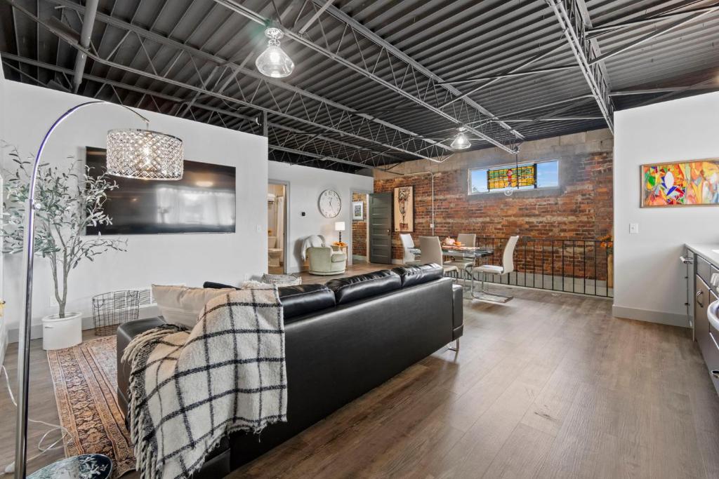 a living room with a couch and a dining room at The 418. An 1866 Build with Modern Comforts in Fort Wayne