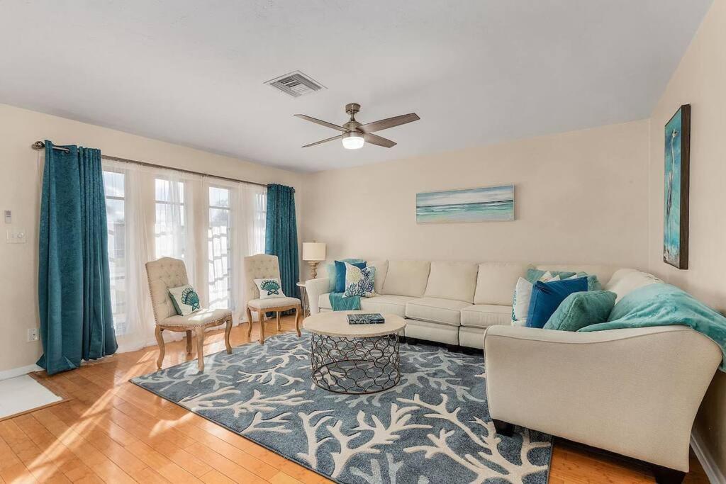 a living room with a couch and a table at Naples Paradise Near The Beach! in Naples