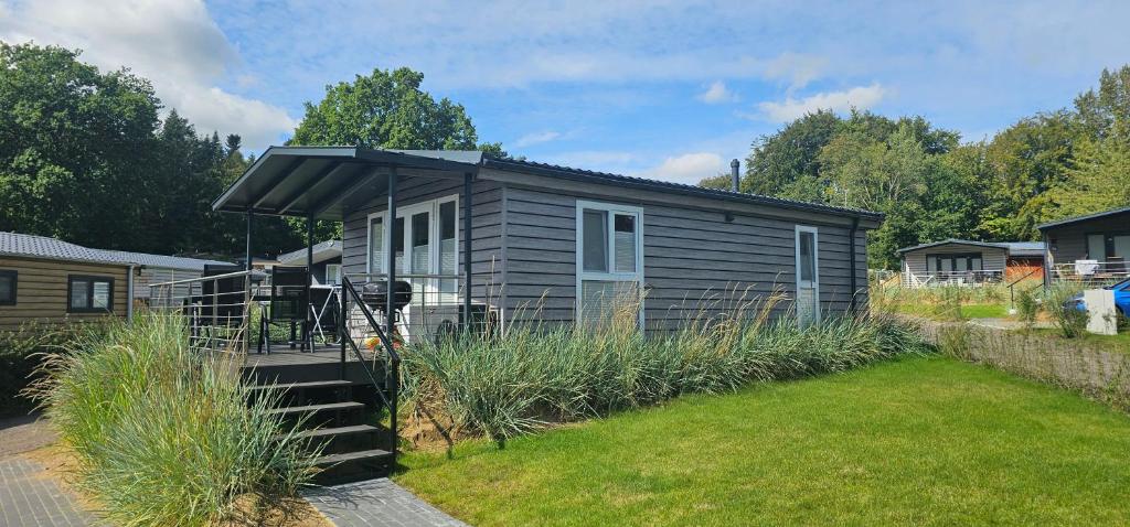a small house with an awning in a yard at Ostseecamp Lübecker Bucht Meeresbrise in Scharbeutz