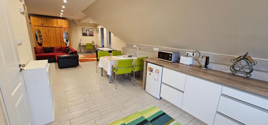 a kitchen and living room with a table and a couch at Boldogfalvi apartman in Debrecen