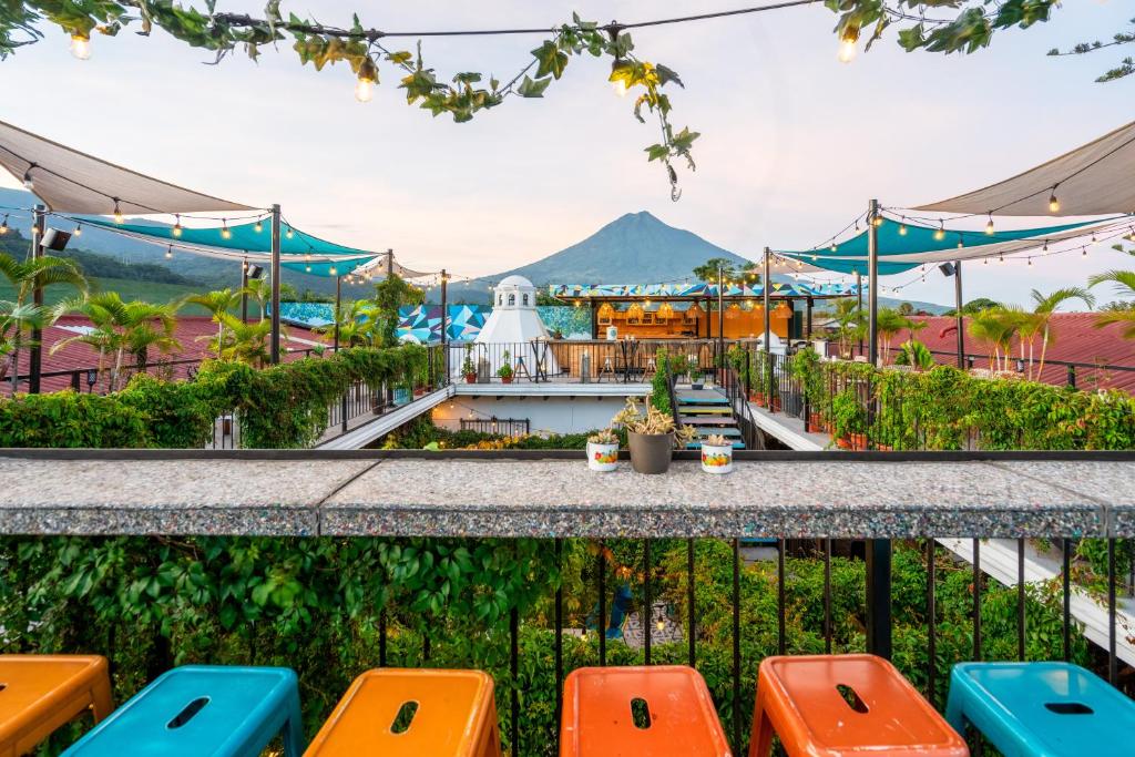 a view from the balcony of a resort with mountains in the background at Adra Hostel in Antigua Guatemala