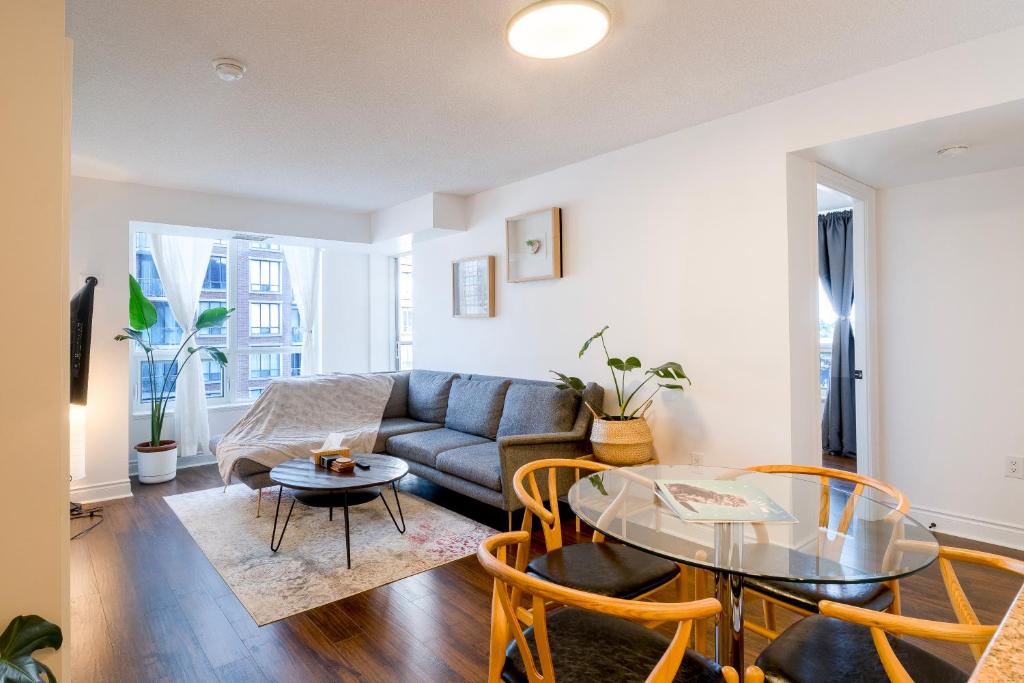 a living room with a couch and a table at Near Yonge Finch Subway 2Bed 2Bath Condo Free Parking in Toronto