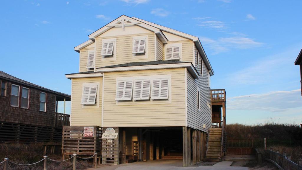 a house that is sitting on top of a garage at OCEANFRONT, Ocean Views, Private Beach Access, Sun Decks, KD229, The Sand Trap in Kill Devil Hills