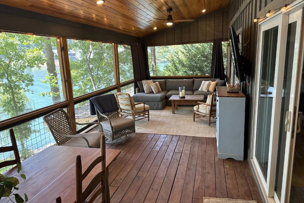 a screened in porch of a house with a living room at Lakeside Hideaway in Waleska