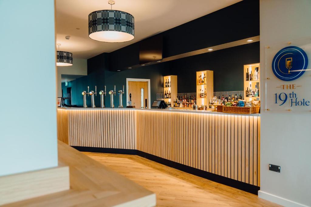 a bar in a restaurant with a counter at The Dunes in Tenby