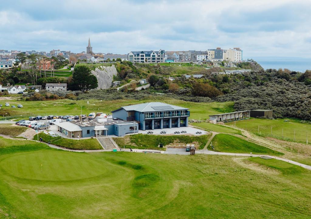 an aerial view of a golf course with a building at The Dunes in Tenby
