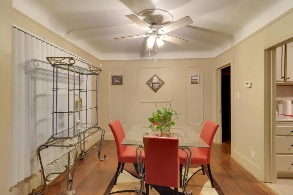a dining room with a table and chairs and a ceiling fan at Detroit Getaway with Fireplace Near Ford Field in Detroit