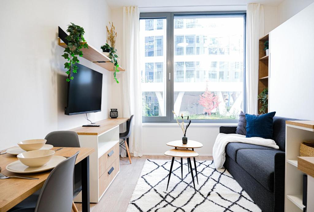 a living room with a couch and a table at MyMozart apartments by Rentero property in Prague