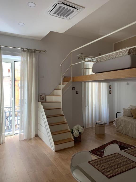 a room with a spiral staircase and a bed at Casa Vacanze - Capodimonte - Centro di Napoli in Naples