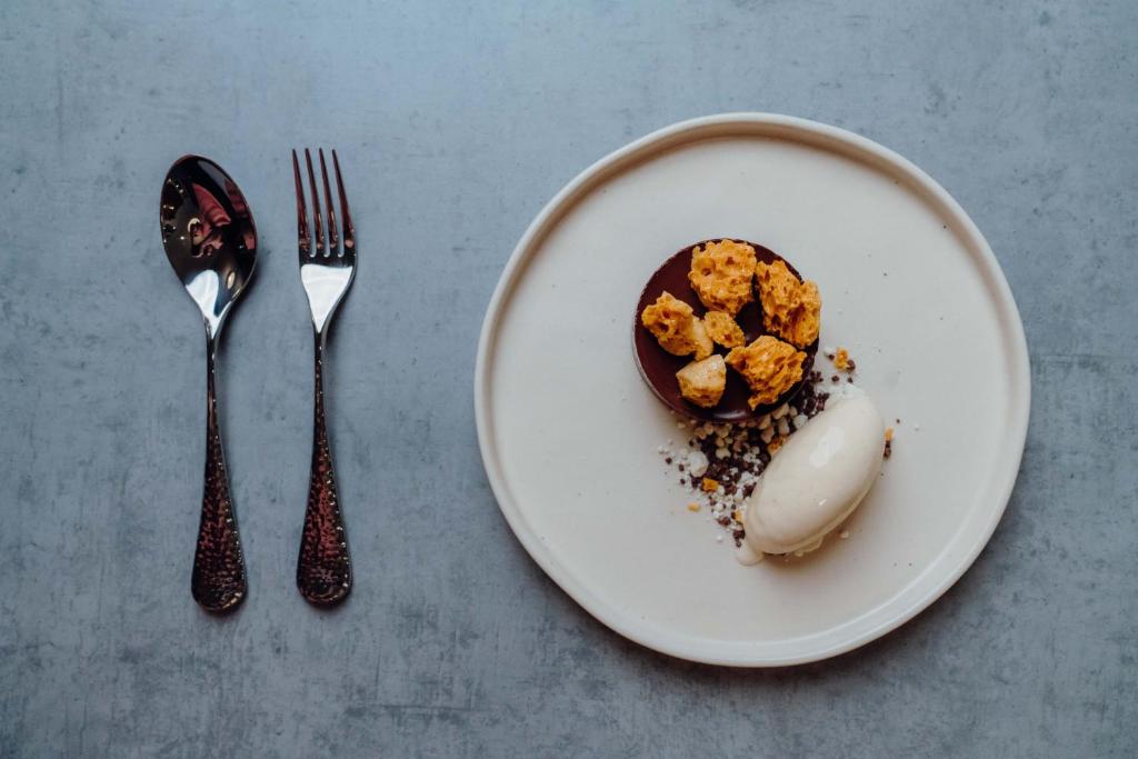 a plate with a dessert on a table with a fork at The Dunes in Tenby