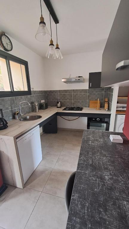 a kitchen with a sink and a counter top at La Kay Sicrié studio de standing in Saint-Pierre