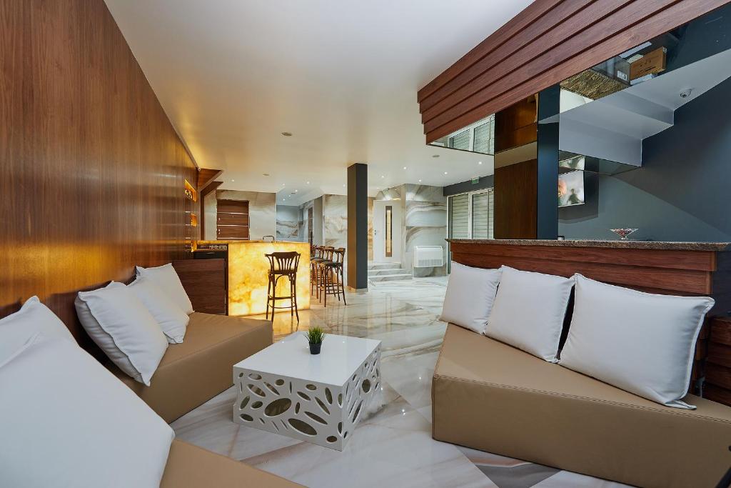 a living room with two couches and a table at Botabara Del Mar Boutique in Pomorie