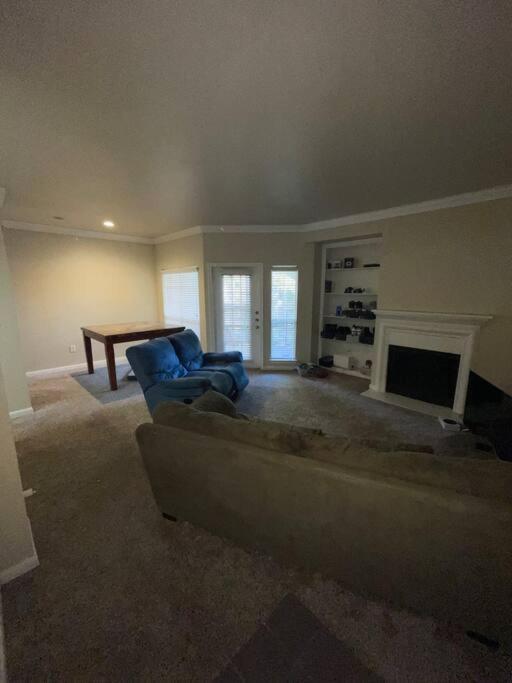 a living room with a couch and a fireplace at Make it your own!(Willow Bend) in Plano