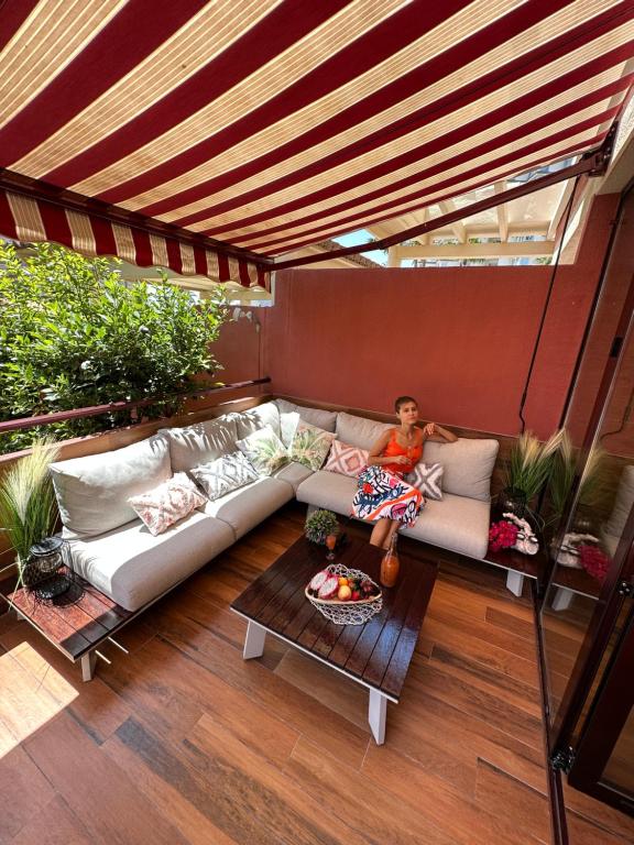 a person sitting on a couch under a pergola at GREEN LAGOON in Calpe
