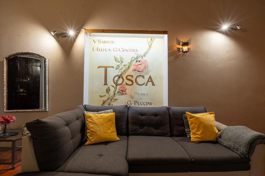 a couch in a room with a large poster on the wall at Apartment Anfiteatro in Lucca