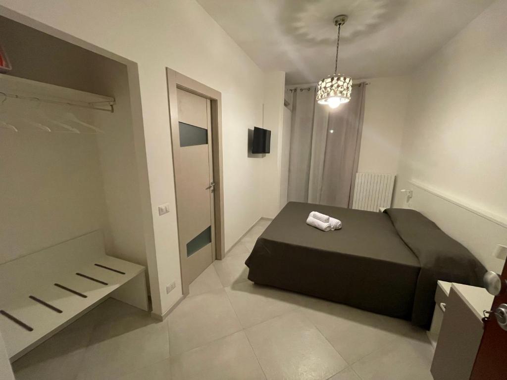 a bedroom with a bed and a chandelier at La Dimora del Maggio in Accettura