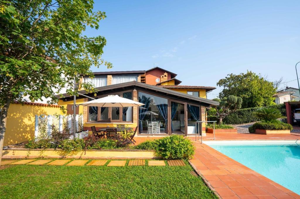 a home with a swimming pool and a house at Sweet Dreams in Peschiera del Garda