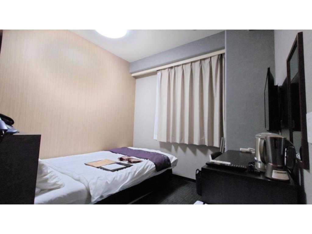 a hotel room with a bed and a tv at Hotel Area One Oita - Vacation STAY 99740v in Oita