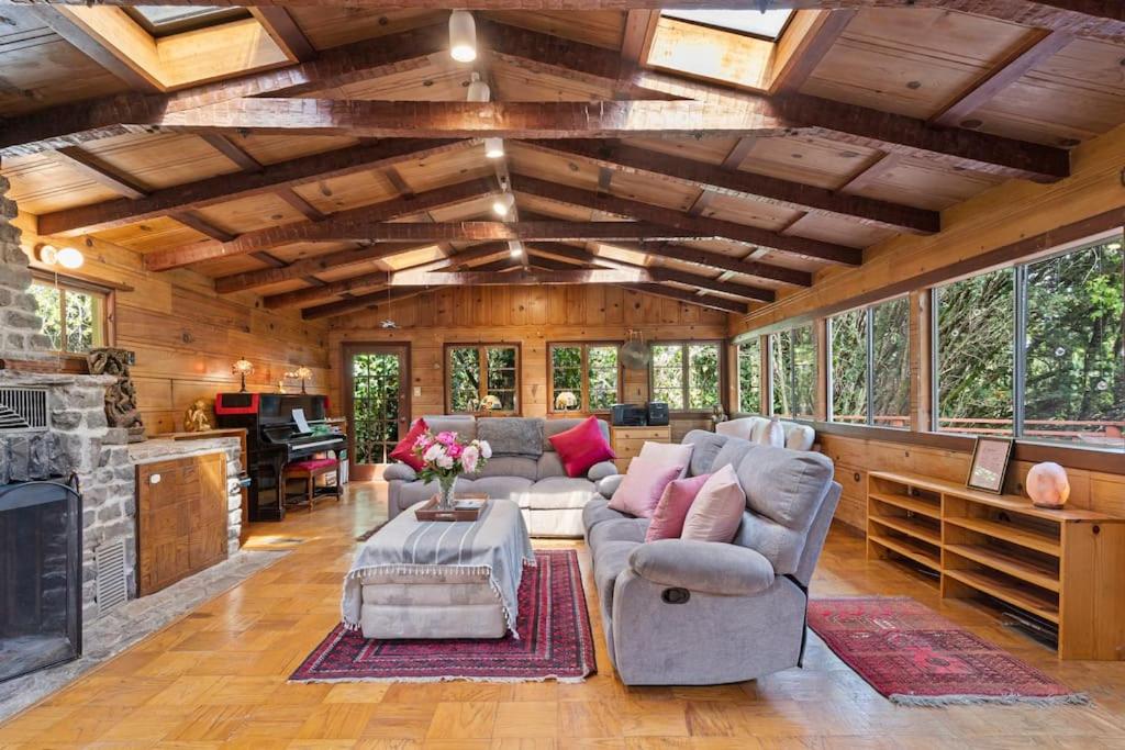 a living room with a couch and a fireplace at Spacious Serene Sanctuary- 14 min to Muir Woods in Mill Valley