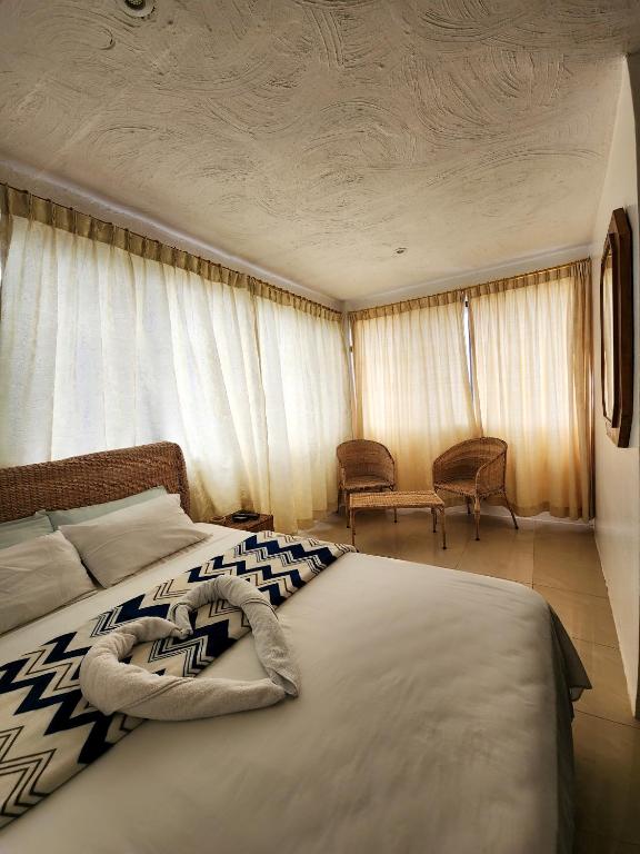 Postel nebo postele na pokoji v ubytování Hostal Poseidon