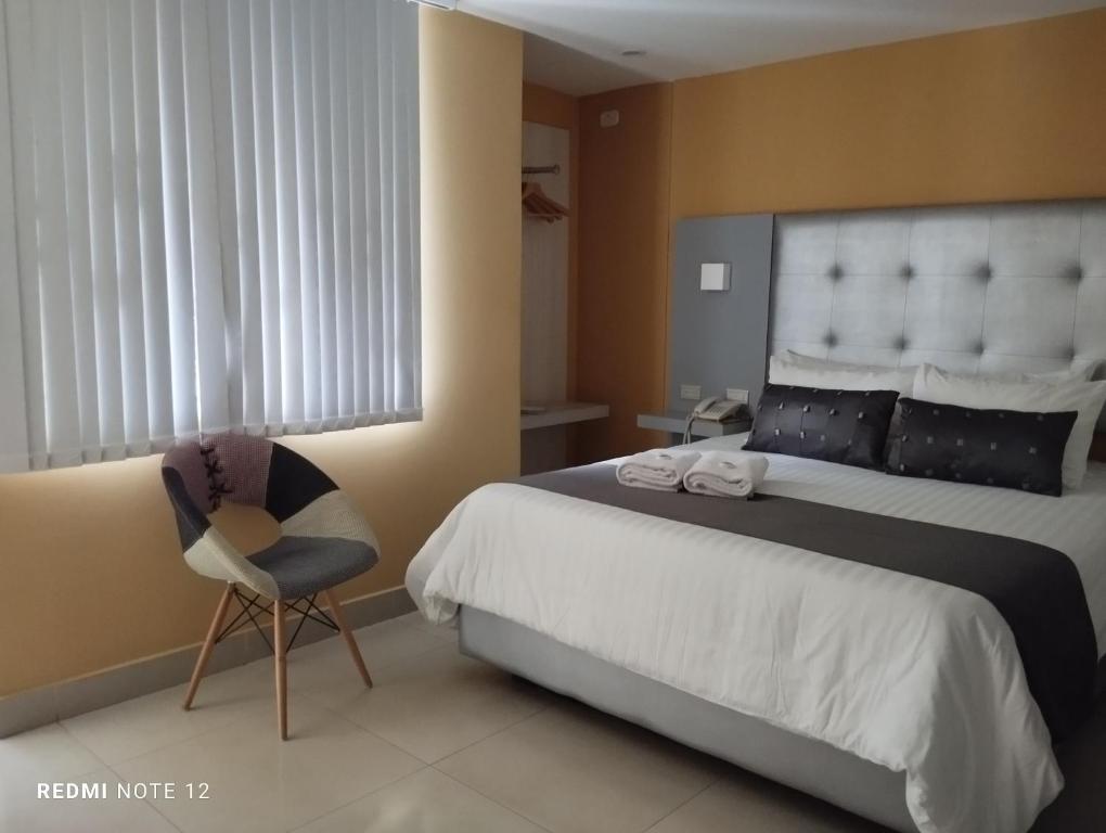 Una cama o camas en una habitación de HOTEl DIBENI PEREIRA