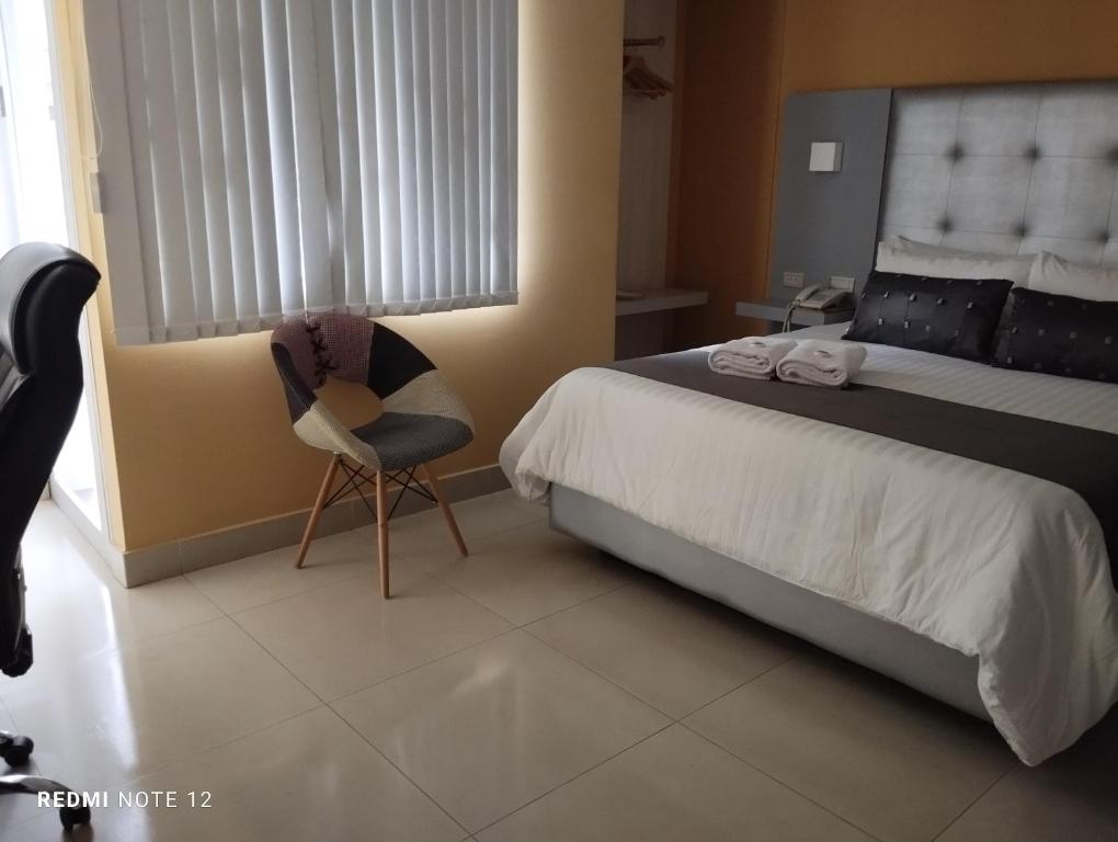 Una cama o camas en una habitación de HOTEl DIBENI PEREIRA