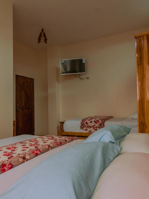 Postel nebo postele na pokoji v ubytování Hostal Poseidon