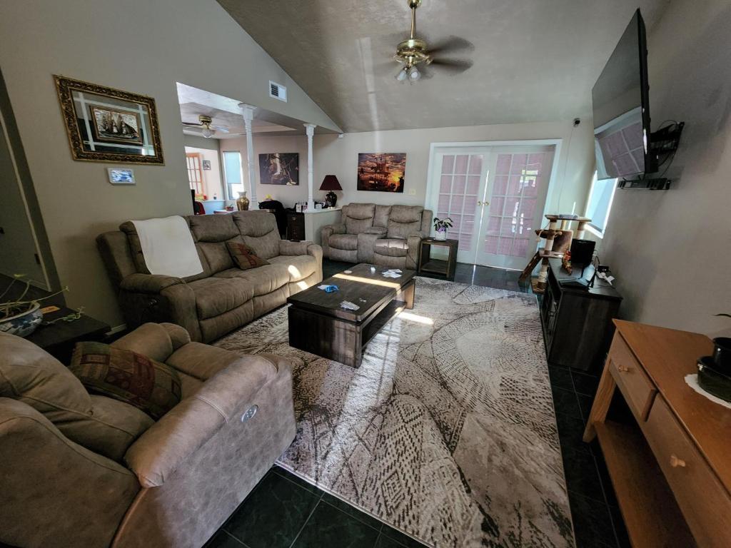 a living room with couches and a coffee table at Buckboard House in Rio Rancho