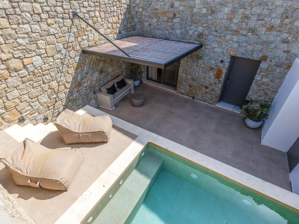 an overhead view of a swimming pool next to a brick building at Villa Evi & Suites in Mikonos