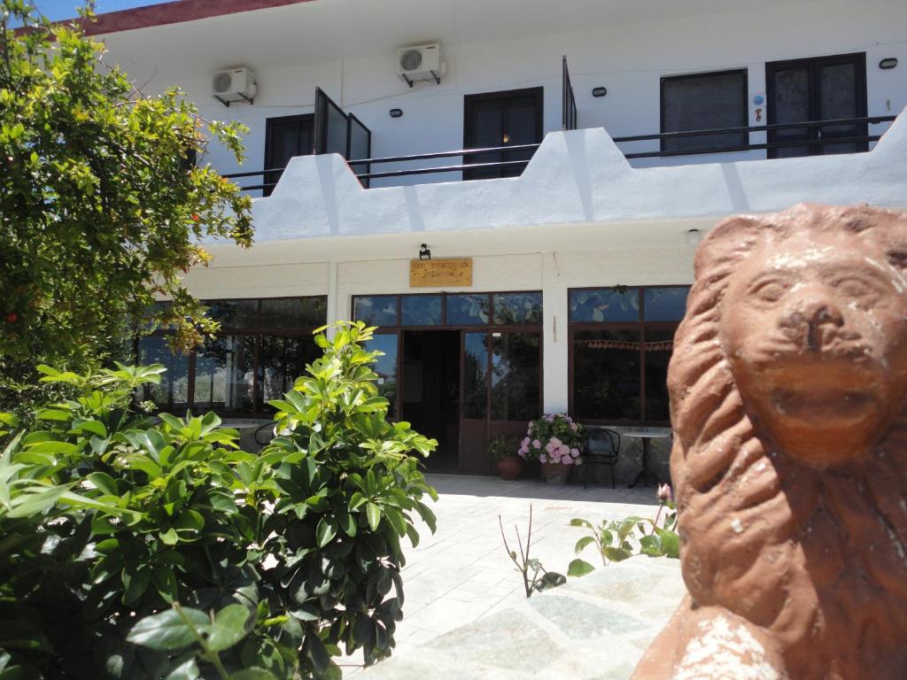 a statue of a lion in front of a building at Archontika Apartments in Kerames