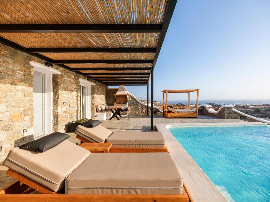 a villa with a swimming pool with two beds at Villa Evi in Mikonos