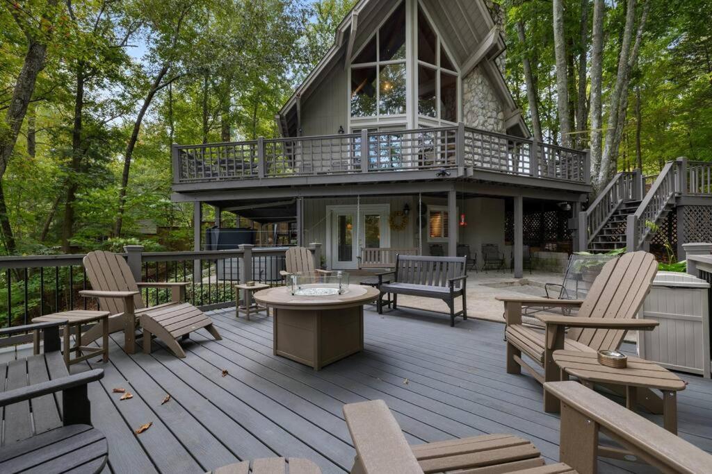 a large deck with chairs and a house at Water's Edge-Lakefront Cabin W/Dock, Views, Etc. in Winchester