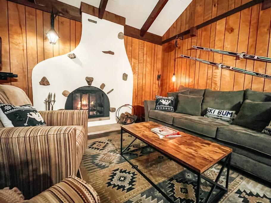 a living room with a couch and a table at Mountain Top Chalet ~ Ski In Out ~ Fully Updated in Bessemer