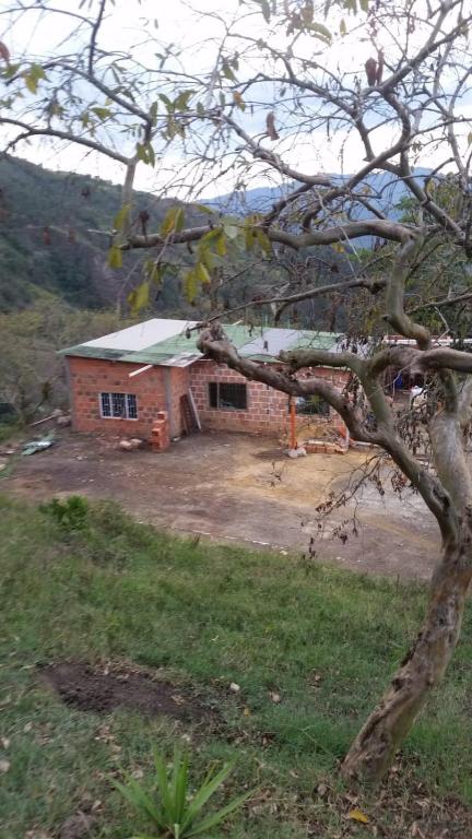 a small brick house with a white roof at CABAÑAS CAMPO ALEGRE 