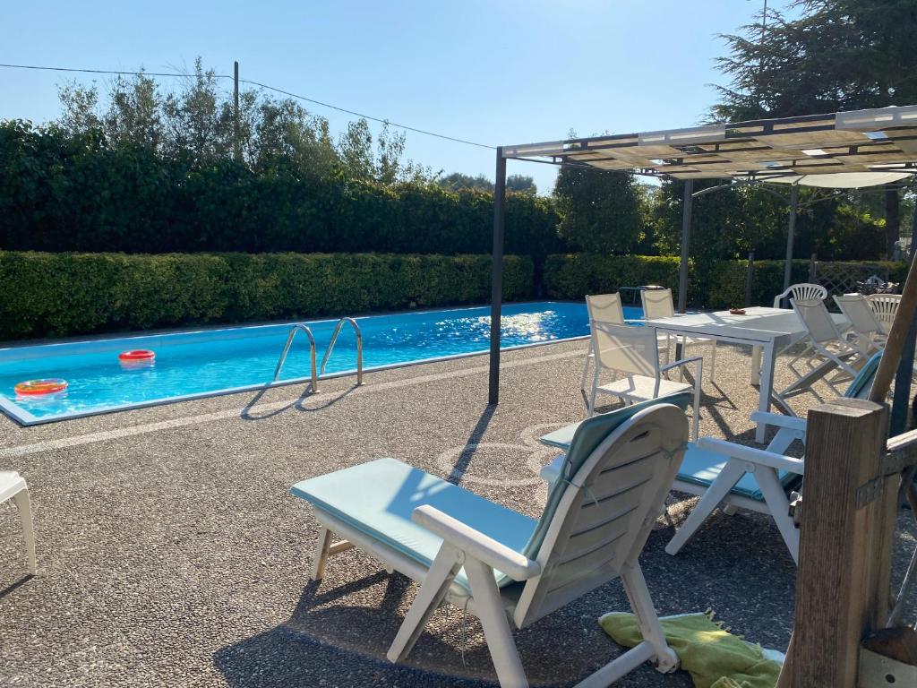 a group of chairs and a pool with a swing at Villa Margherita in Lecce