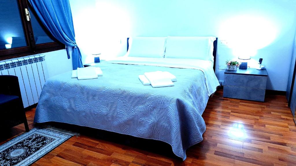 a bedroom with a large bed with two towels on it at Venice Suites in Mestre