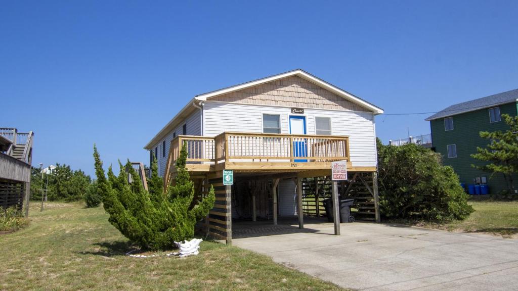 a large house with a deck on top of it at KH146, Camelot- Oceanside, Screened Porch, Close to Shopping and Restaurants! in Kitty Hawk