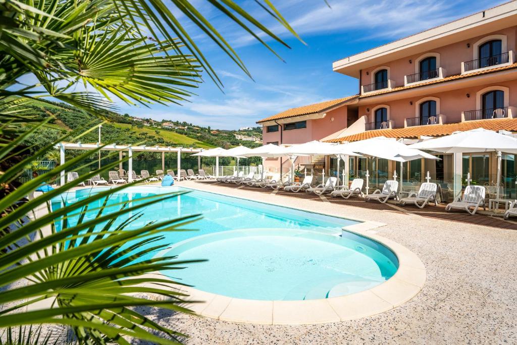 a swimming pool in front of a hotel at Hotel Villa Elena in Tortoreto Lido