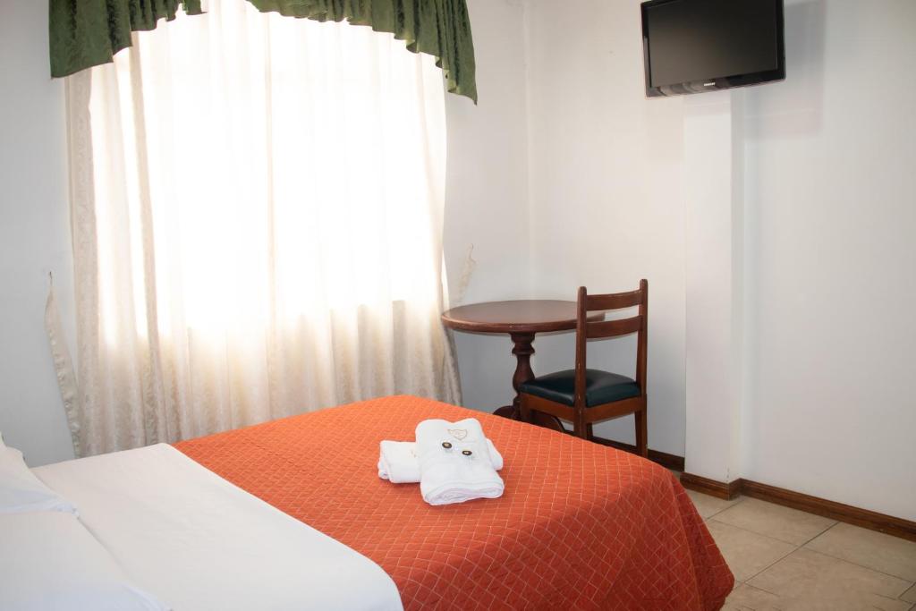 Postel nebo postele na pokoji v ubytování Hotel Colonial