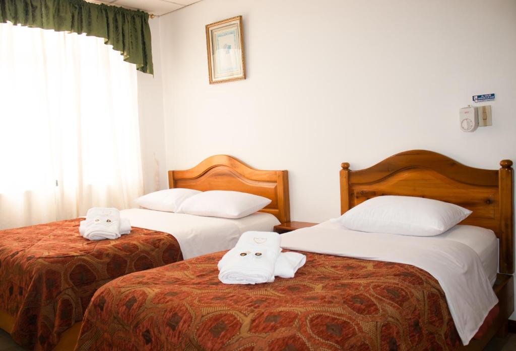 Postel nebo postele na pokoji v ubytování Hotel Colonial
